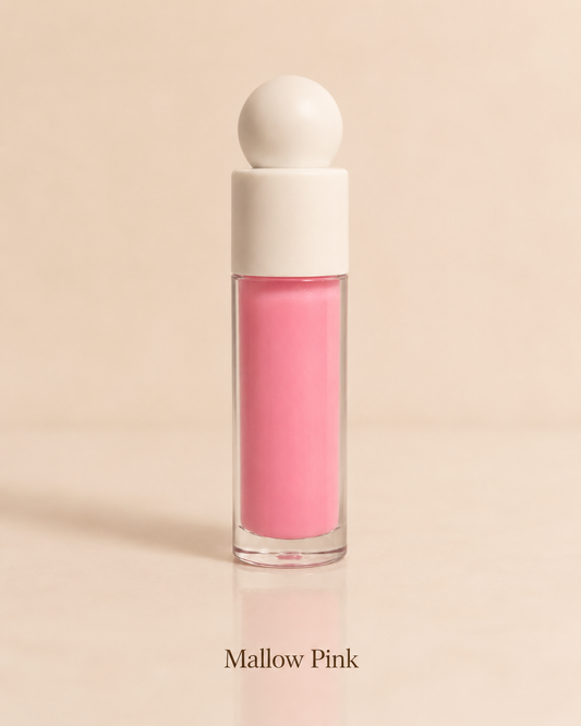Pink lip gloss with a white cap on a beige background