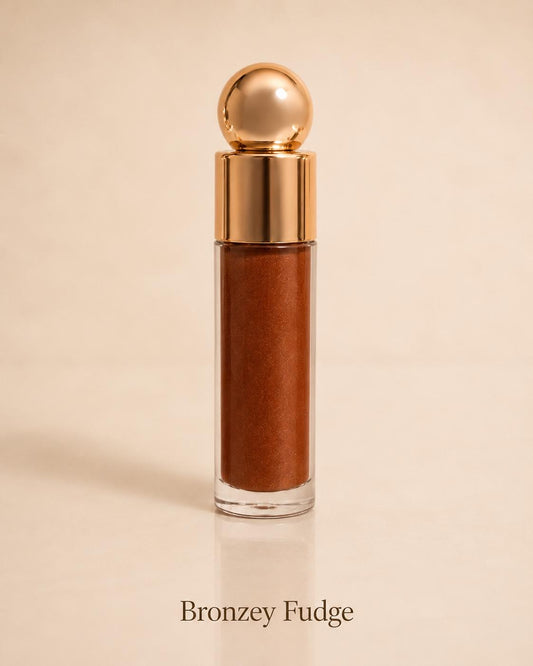 Bronzey Fudge shimmering bronze lip gloss on a warm beige background