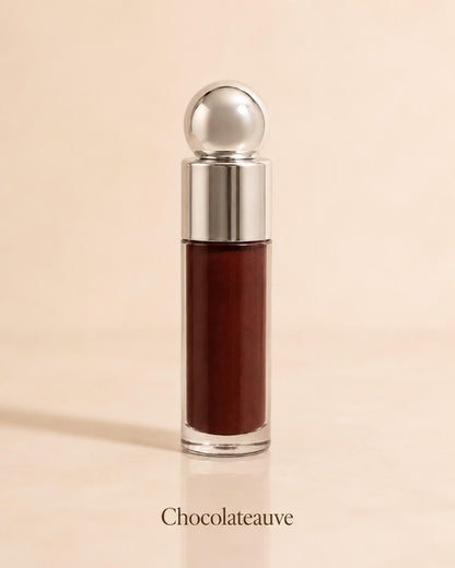 Chocolateauve deep brown lip gloss on a warm beige background