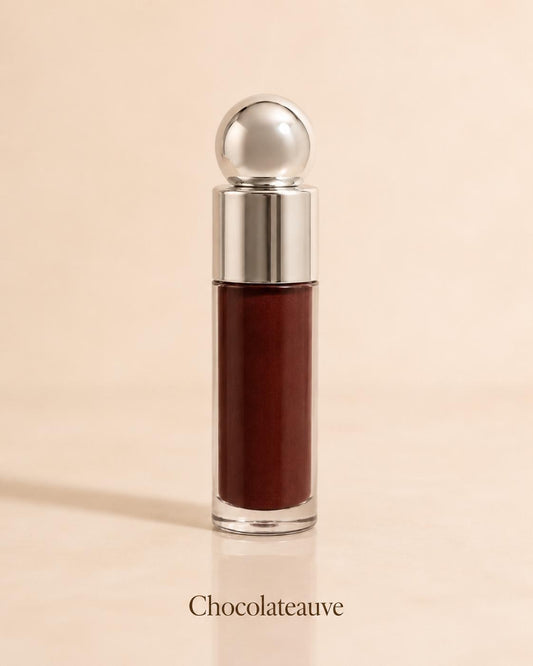 Chocolateauve deep brown lip gloss on a warm beige background
