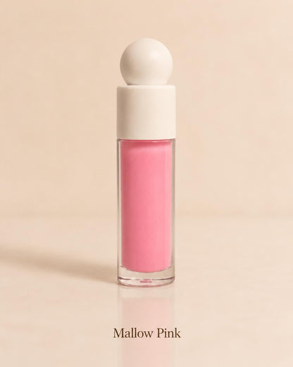 Mallow Pink lip gloss in a soft pink shade on a warm beige background