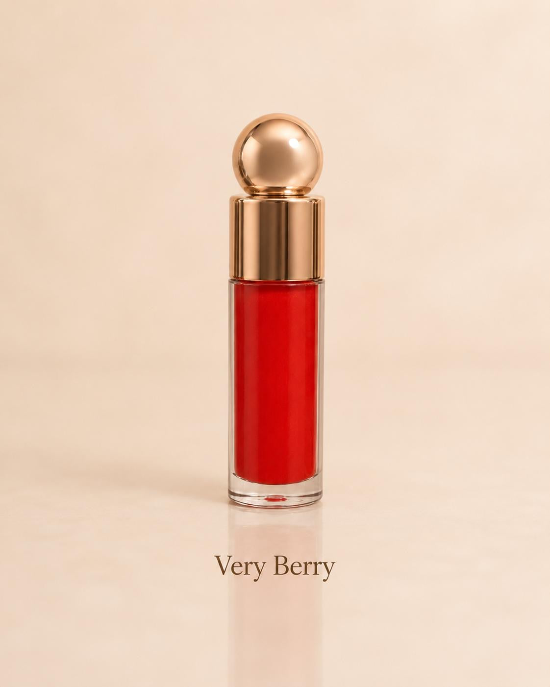 Very Berry bright red lip gloss on a warm beige background