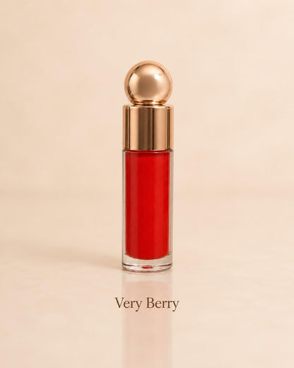 Very Berry bright red lip gloss on a warm beige background